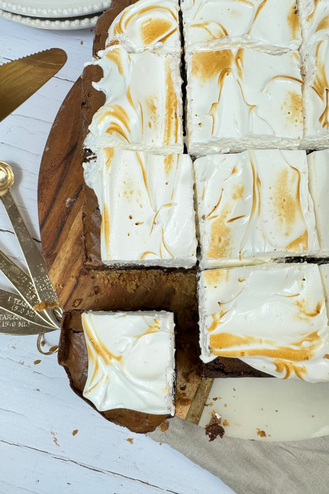 S'mores Brownies. The corner of the s'mores brownie with a biscuit base, triple chocolate brownie and mallow frosting.